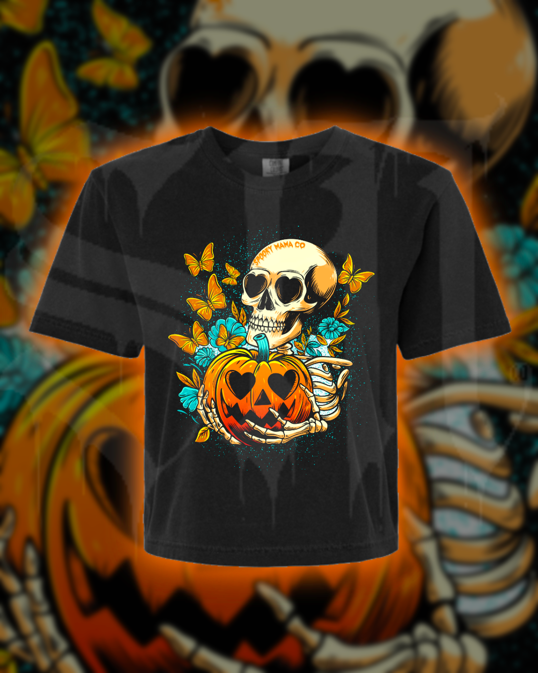 Black t-shirt with a Halloween-themed design featuring a skull and pumpkin on a colorful background.